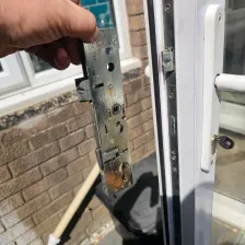Rusty corroded multi-point lock mechanism held next to a door