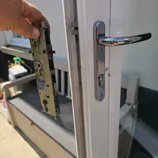 Old multi-point lock mechanism removed next to a uPVC French door